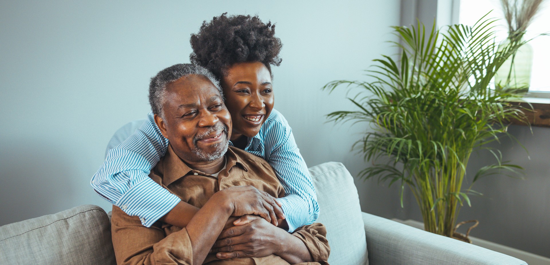 Adult daughter visits senior father in assisted living home.